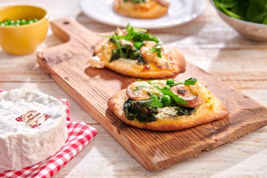 Mini pizzas with Le Rustique Camembert spinach, peas and Cumberland sausage
